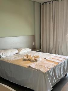 two dogs laying on a bed in a bedroom at Apartamento 313 Bobz Concept in Cajueiro +9 photos