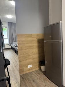 a kitchen with a stainless steel refrigerator in a room at Hansa Pension 2 Hamburg - Ruhige Zimmer mit Gemeinschaftsküche in Hamburg +4 photos
