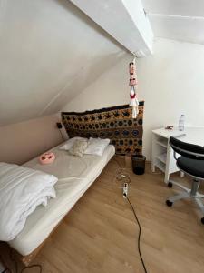 a bedroom with a bed and a desk and a table at Studio au coeur de Aix in Aix-en-Provence