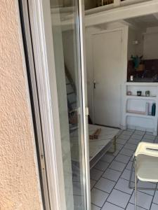 a small kitchen with a glass door in a room at Studio au coeur de Aix in Aix-en-Provence
