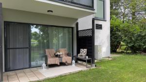 a screened in patio with two chairs and a table at Gold Luxury Romantic SPA Suite Private Jacuzzi & Sauna in Kołobrzeg