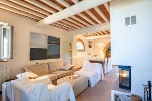 a living room with a couch and a table at Private Tuscan Villa with Infinity Pool & Views in Vagliagli