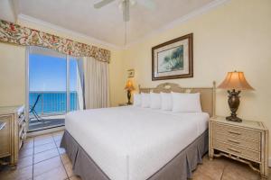 a bedroom with a large bed and a large window at Island Royale 404 in Gulf Shores +28 photos