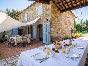a table with a white table cloth on a patio at Private Tuscan Villa with Infinity Pool & Views in Vagliagli