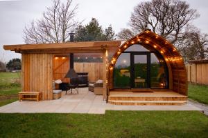 a gazebo with an arch and lights at Hillend by Wigwam Holidays in Todmorden