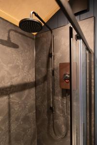 a shower with a shower head in a bathroom at Hillend by Wigwam Holidays in Todmorden