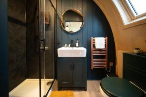 a bathroom with a sink and a mirror at Hillend by Wigwam Holidays in Todmorden +5 photos