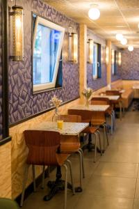 a row of tables and chairs in a restaurant at UNISOTEL Le Havre in Le Havre