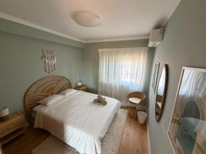 a bedroom with a white bed and a window at Capsule Marisol Family Retreat in Corroios