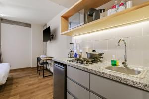 a kitchen with a sink and a counter top at El Pocito by Homirent in El Jacal