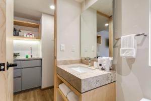 a bathroom with a sink and a mirror at El Pocito by Homirent in El Jacal +14 photos