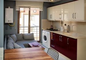 a kitchen and living room with a couch and a table at Eylül Homes in Trabzon