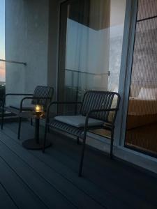 a balcony with a bench and a candle on it at Studio in Dimri Residence in Bucharest