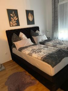 a bedroom with two beds and a rug at Anonim Plus in Vrdnik