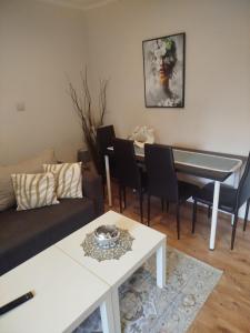 a living room with a couch and a table at Apartamenty nad Brdą in Zapędowo +7 photos