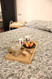 a tray of fruit and nuts on a bed at B&B Camilla in Rimini