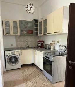 a kitchen with a washing machine and a washer at Tirana Terminal Stay in Tirana