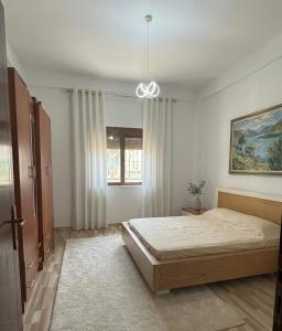 a bedroom with a bed and a window at Tirana Terminal Stay in Tirana