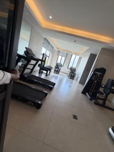 a gym with several treadmills and treadleys in a room at Serene Keys Homes in Otinshi