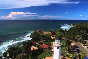 an aerial view of the ocean and a lighthouse at Above the Plaza 6 (with A/C) in Rincon