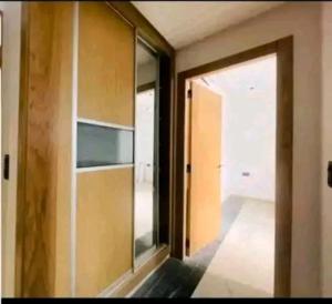 a room with a glass door and a room with a hallway at Résidence Nour in Monastir