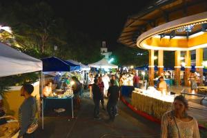 a crowd of people at an outdoor market at night at Above the Plaza 6 (with A/C) in Rincon