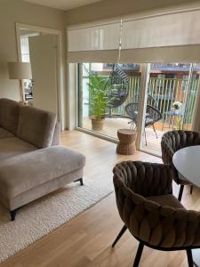 a living room with a couch and a table at Modern apartment with a private garage in Lørenskog Oslo in Lorenskog