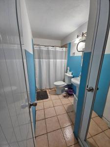 a bathroom with a shower and a toilet and a sink at Above the Plaza 6 (with A/C) in Rincon +28 photos
