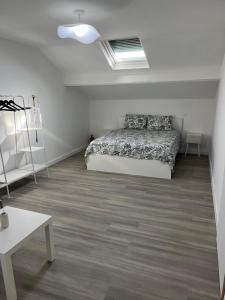 a bedroom with a bed in a white room at Maison Teiss in Aigues-Mortes