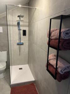 a bathroom with a shower with a glass door at Maison Teiss in Aigues-Mortes