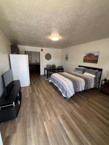 a large bedroom with a bed and a desk at Green River Inn Apartments in Green River