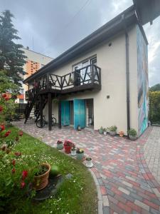 a building with a patio with plants and flowers at Shark in Liepāja
