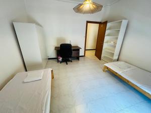 ein Zimmer mit einem Bett, einem Schreibtisch und einem Stuhl in der Unterkunft Double and Triple Rooms near Principe Station Shared Bathroom in Genua