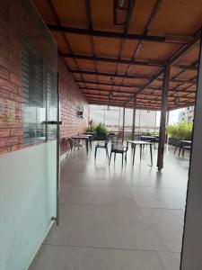 a patio with tables and chairs in a building at Serene Keys Homes in Otinshi