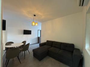 a living room with a couch and a table at Apartmani Srdanovic in Tivat