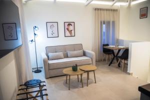 a living room with a couch and a table at Akrolithos apartments 1st floor in Platy +23 photos