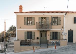 a large house with a balcony and windows at Akrolithos apartments 1st floor in Platy