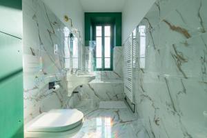 a white bathroom with a toilet and a sink at Casa Miasto - Chambres d'hôtes & Spa in Aspet +65 photos