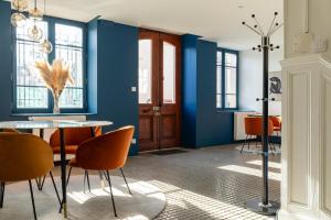 a dining room with blue walls and a table and chairs at Casa Miasto - Chambres d'hôtes & Spa in Aspet