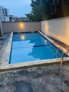 a swimming pool with blue water on a building at Modern Luxury 2BR Spacious Cozy 24hr Power in Lekki