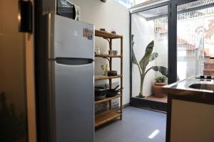 a white refrigerator in a kitchen with a window at B&B Camilla in Rimini