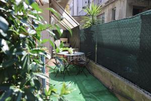 a small patio with a table and chairs on a balcony at B&B Camilla in Rimini