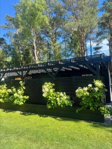 a bridge in a park with some plants at Höllviksstugan in Höllviken