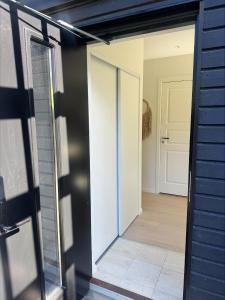 an open door leading to a room with a hallway at Höllviksstugan in Höllviken