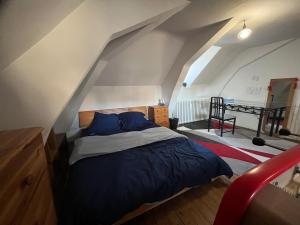 a bedroom with a bed in an attic at La maison aux volets bleus in Laval +30 photos