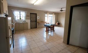 a kitchen with a table in the middle of a room at Ligema Lodge in Malelane