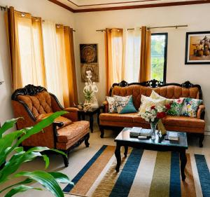 a living room with two couches and a coffee table at Romar's Place Roxas Orientl, Mindoro in Roxas