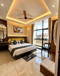a bedroom with a bed and a large window at Hotel Shakuntla Palace - 400 Meters away from Vishnu Pad Temple 7 mins walk in Gaya