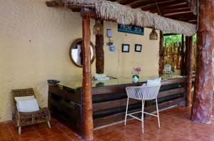 a bar in a room with a table and chairs at Chuk-Kay by ÓOL Hotels in Holbox Island