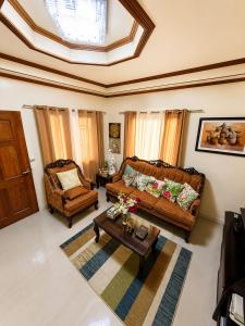 a living room with a couch and a table at Romar's Place Roxas Orientl, Mindoro in Roxas